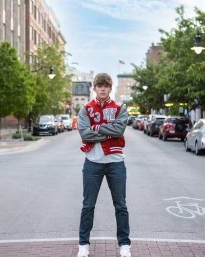 senior boy poses for his senior photos in Downtown Lafayette